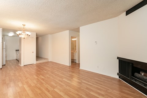 a living room with a fireplace and a wooden floor
