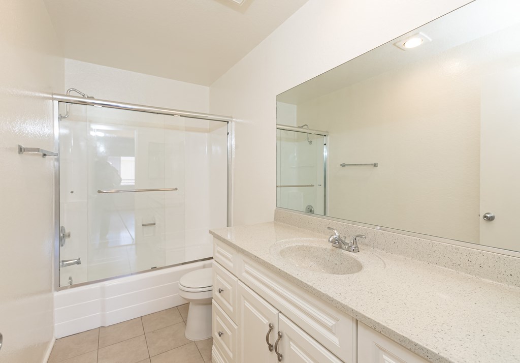 Bathroom with White Cabinets and Bathtub/Shower