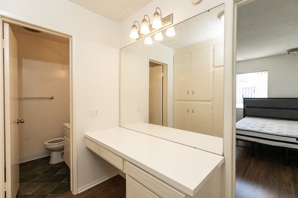 Bathroom with White Cabinets and Hardwood Floors
