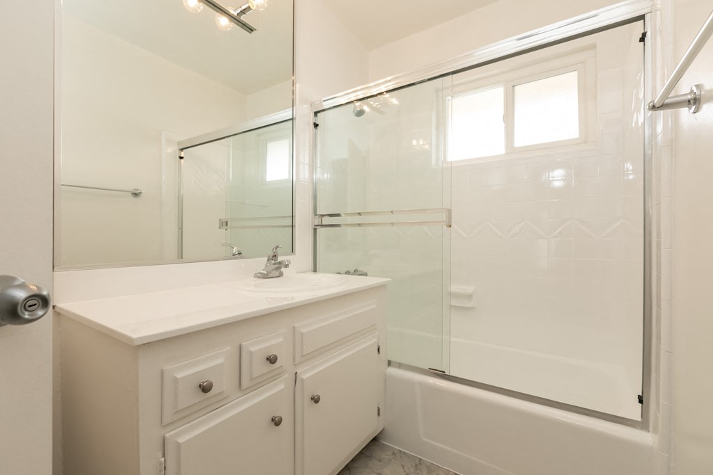 Bathroom with White Cabinets and Bathtub/Shower