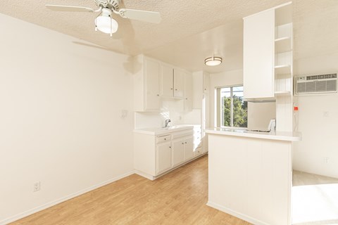 a kitchen with white cabinets and a white counter top