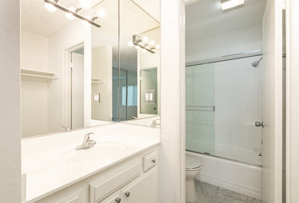 Bathroom with White Cabinets and Bathtub/Shower