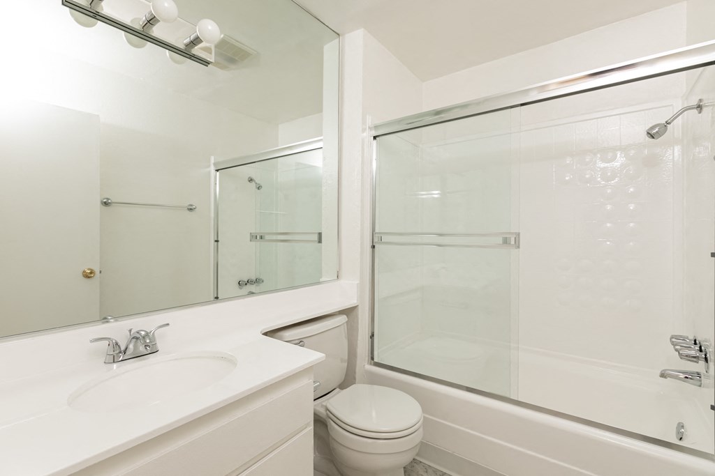 Bathroom with White Cabinets and Bathtub/Shower