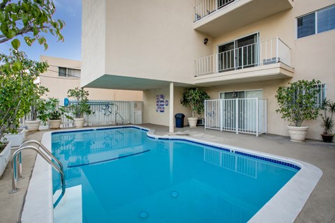a swimming pool in front of a building with a pool
