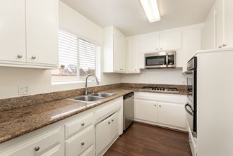 Kitchen with Stainless Steel Appliances and White Cabinets