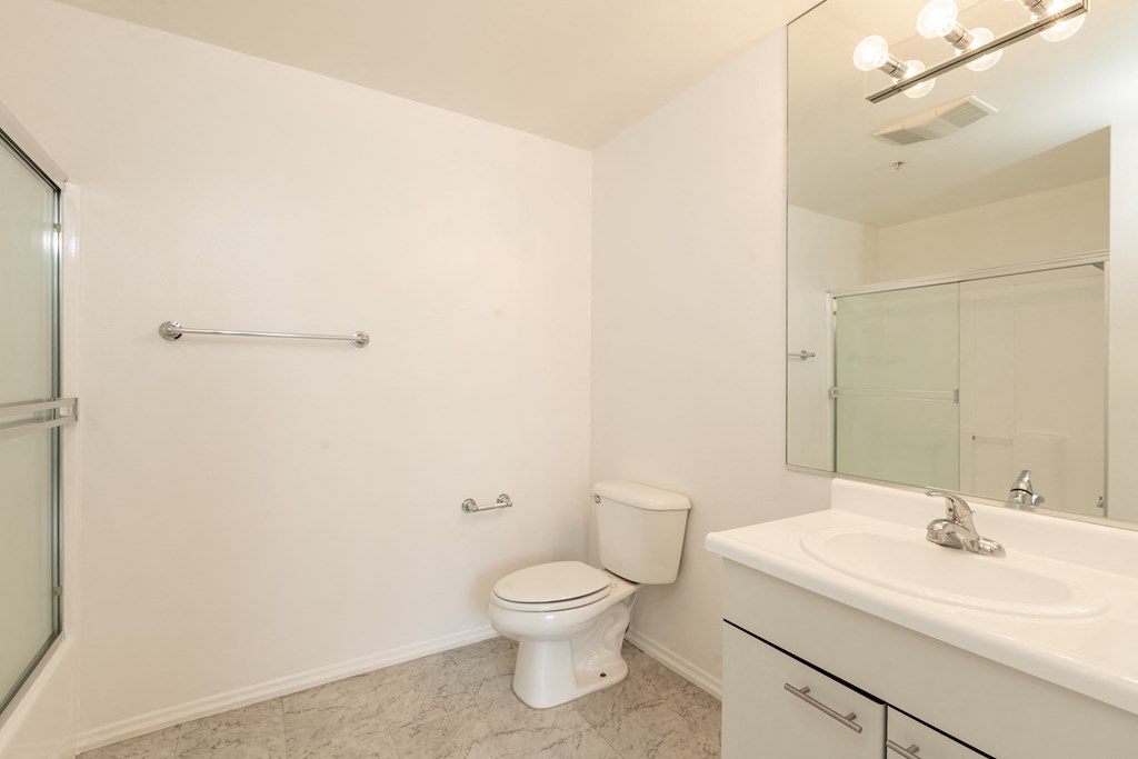 Bathroom with White Cabinets and Bathtub/Shower
