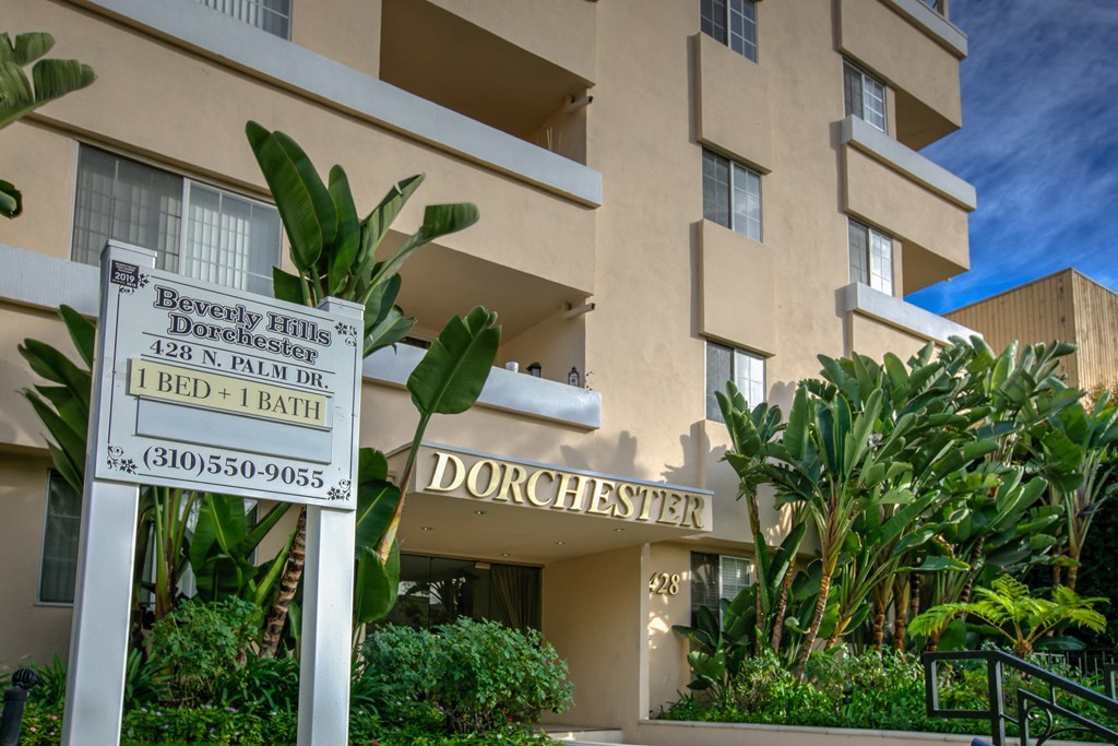 a sign in front of a building with a apartment building