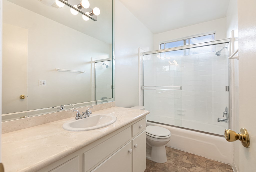 Bathroom with White Cabinets and Bathtub/Shower