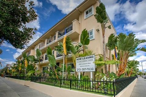a building with a now leasing sign in front of it