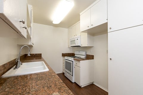 the preserve at ballantyne commons apartment kitchen with white appliances and white cabinets