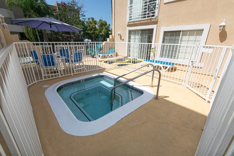a jacuzzi in the pool area of a resort unit with a balcony