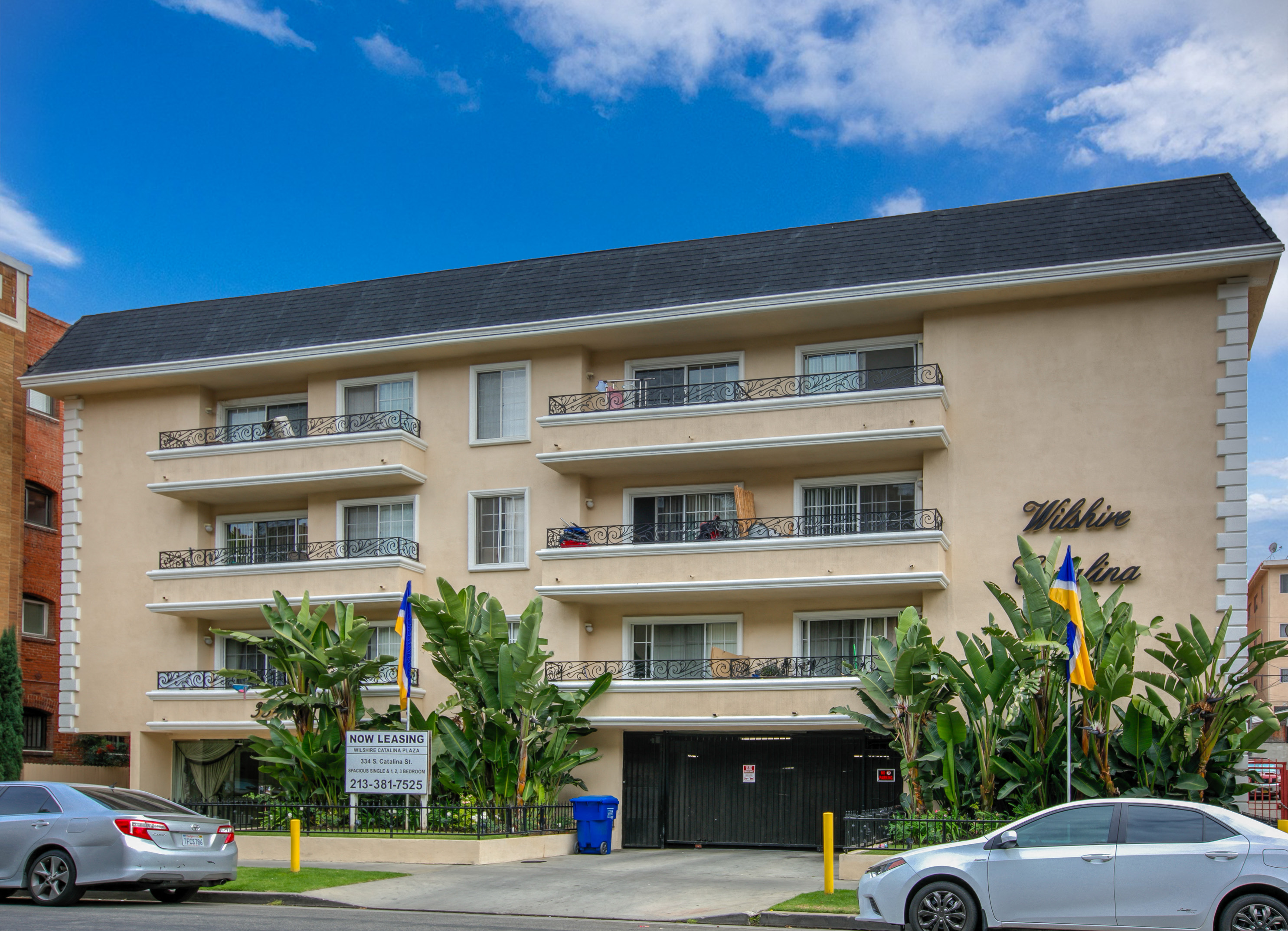 an apartment building with cars parked in front of it