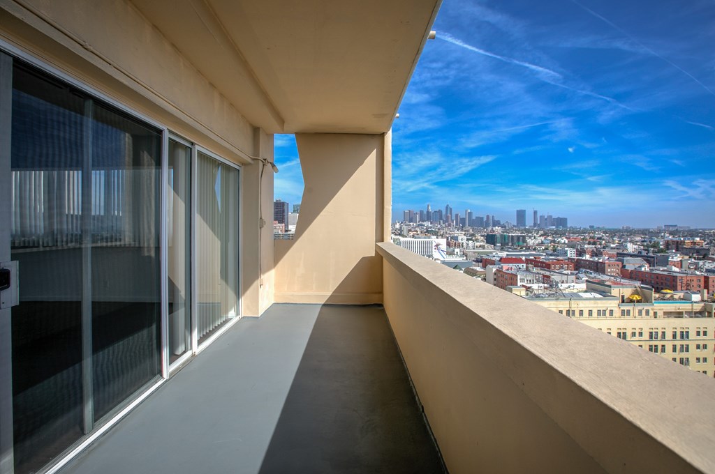 A balcony with a view of a cityscape.