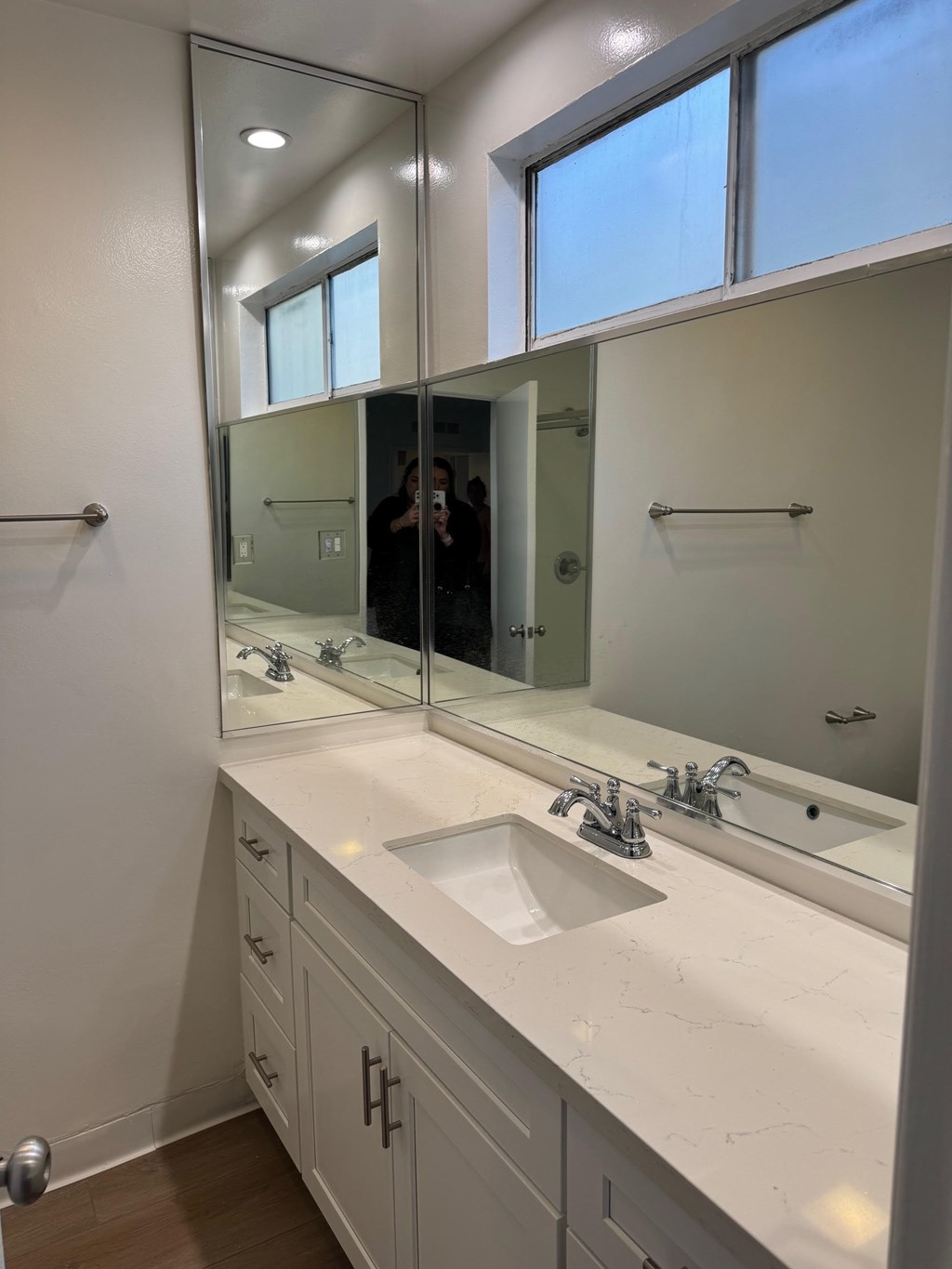 Bathroom with sink, mirror and window.