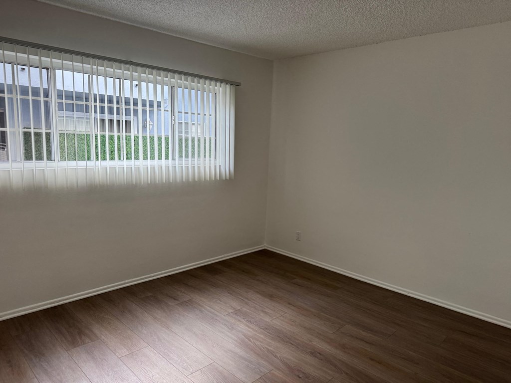 Bedroom with wood flooring and window