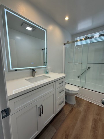 Bathroom with shower and wood flooring