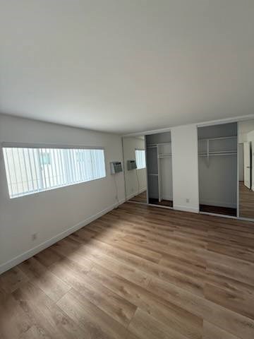 Bedroom with wood flooring