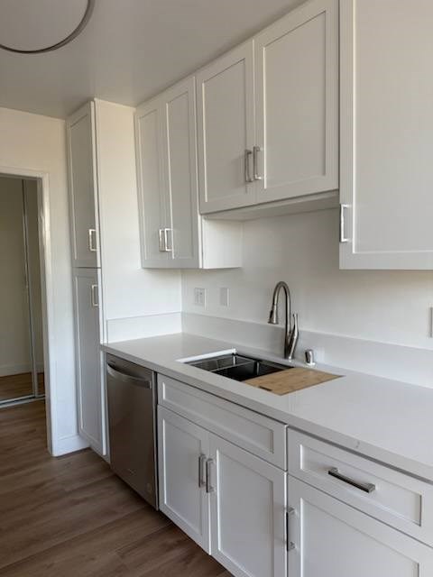 Kitchen with white cabinets and wood flooring