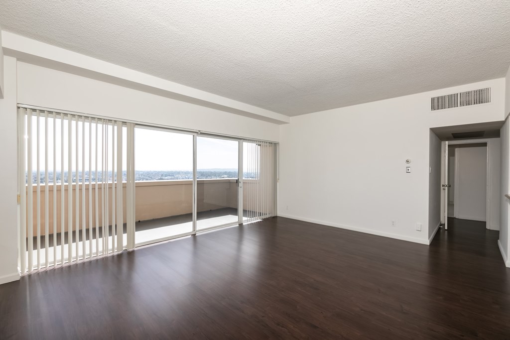 A room with wooden floors and white walls.