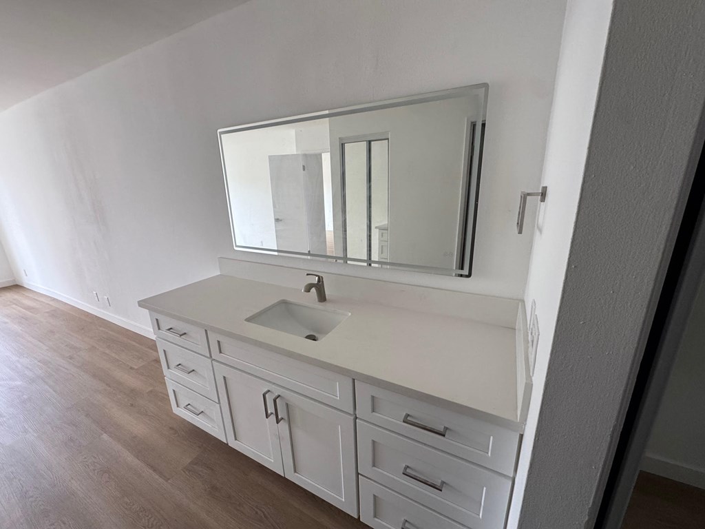 White Vanity and Wooden Flooring
