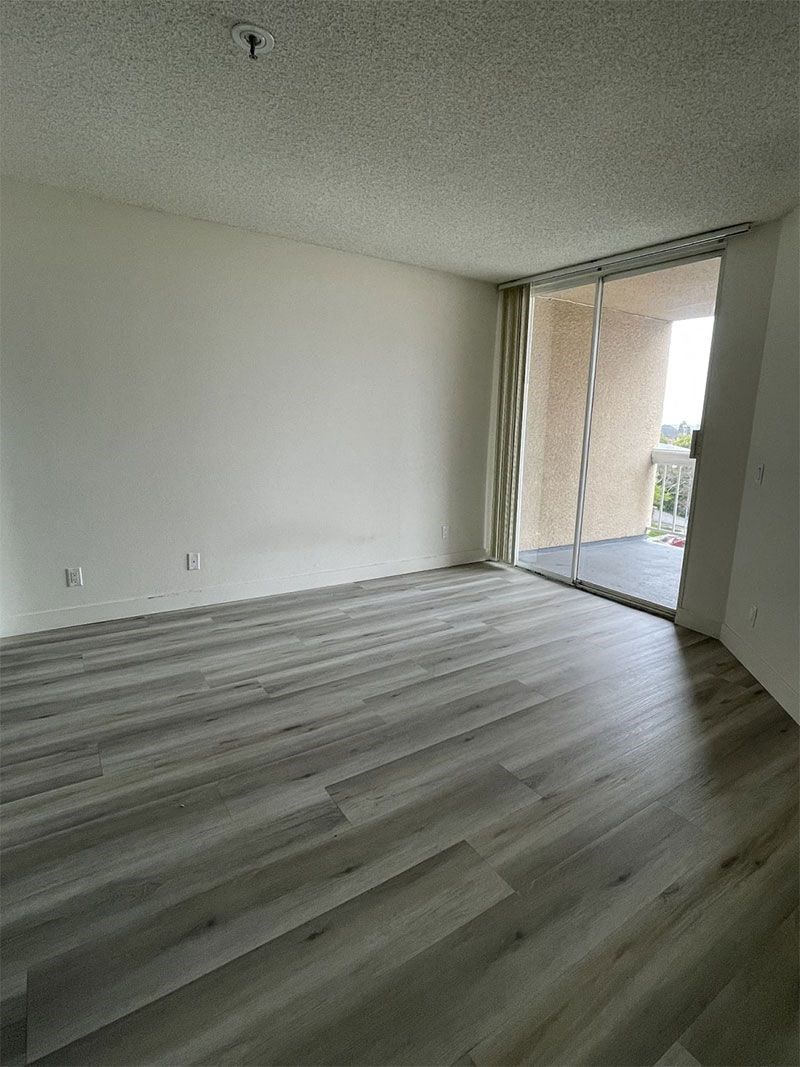 an empty living room with a sliding glass door