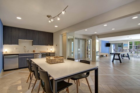 A modern kitchen with a dining table and chairs.