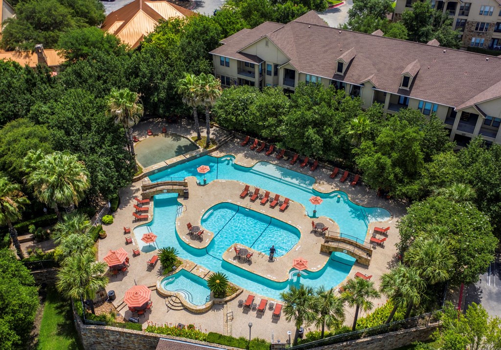 an aerial view of the resort style pool and lazy river at The Verandah, Austin, Texas