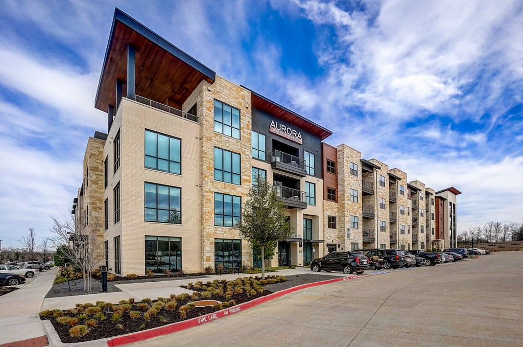 a large building with a flag on the side of it at Aurora Watson Branch, Texas