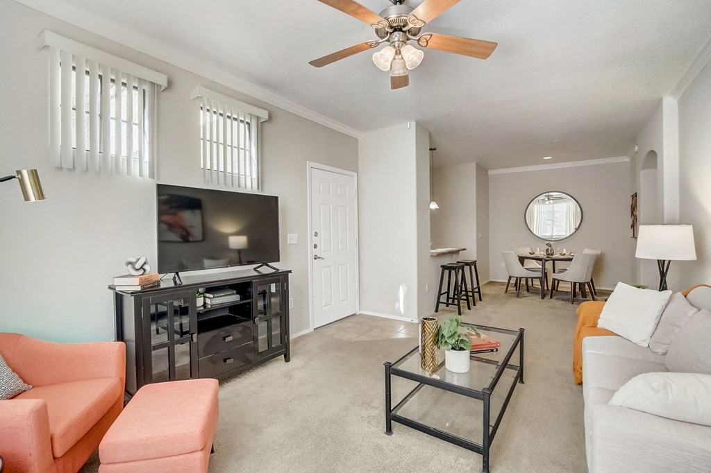 a living room with a ceiling fan and a tv  at Adiamo Palm Valley, Goodyear, AZ