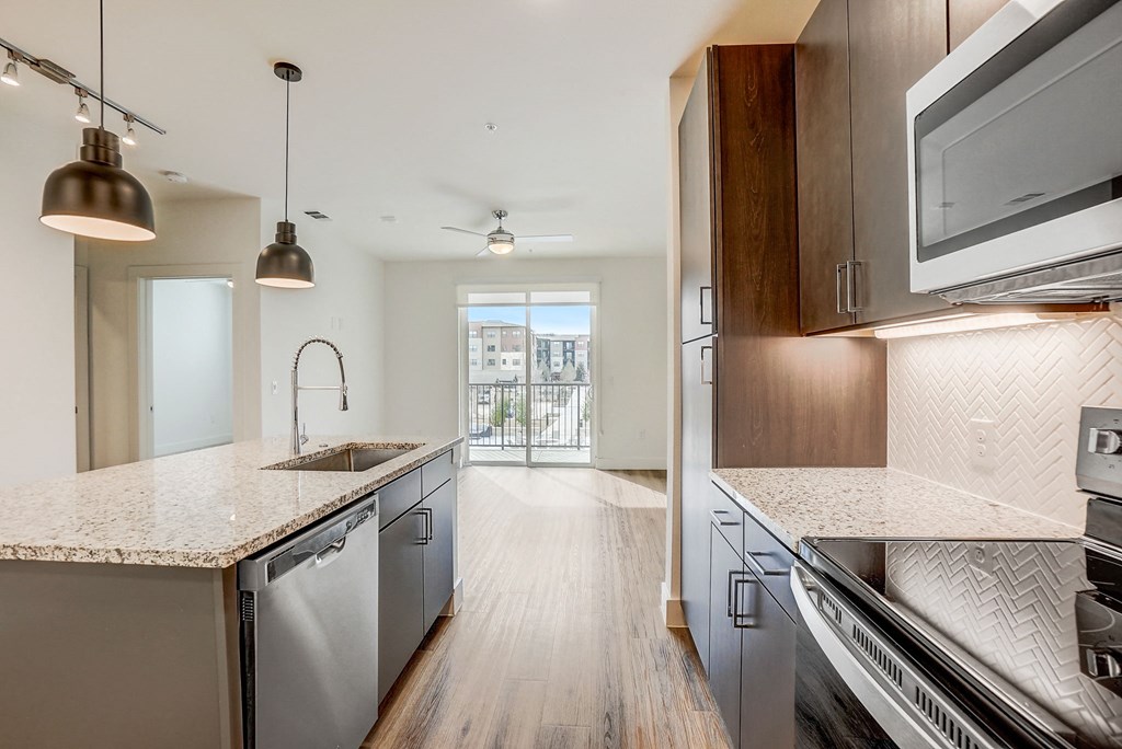 an open kitchen with marble counter tops and stainless steel appliances  at Aurora Watson Branch, Mansfield, 76063