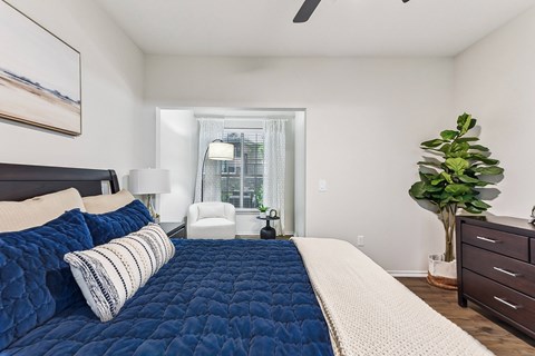Spacious bedroom with reading nook and natural light at Stone Oak @ Parmer Apartments, Austin, Texas