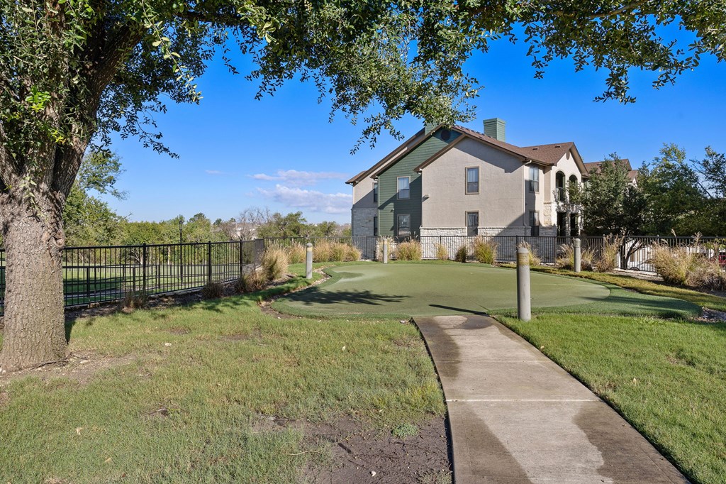 a golf course in front of a house at The Fairways at Star Ranch, Hutto, Texas