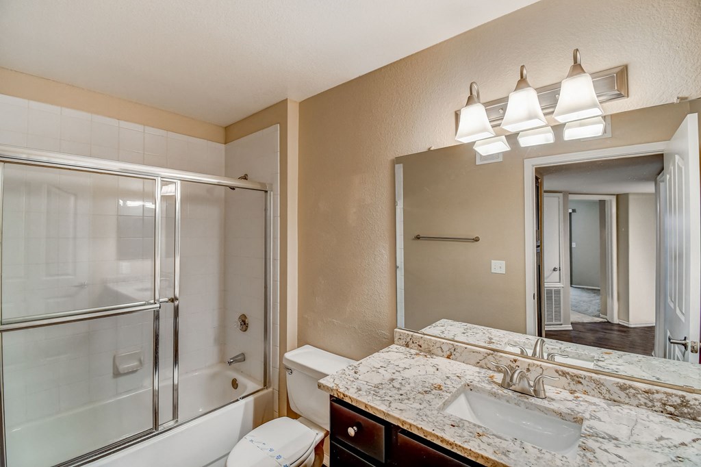 a bathroom with a sink and a mirror and a shower  at San Montego Apartments, Arizona, 85206