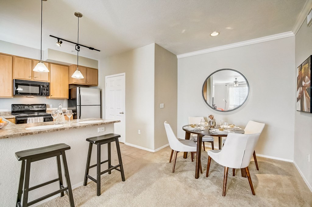 an open kitchen and dining area with a dining table and chairs  at Adiamo Palm Valley, Goodyear, Arizona