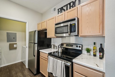 A kitchen with wooden cabinets and a black stove top oven.
