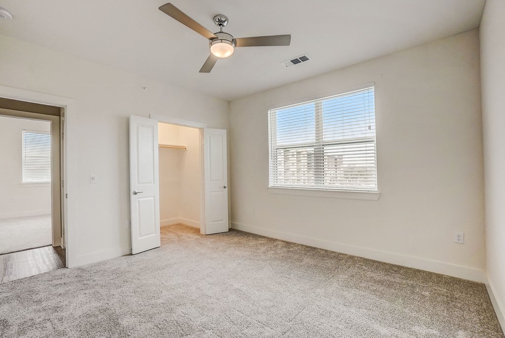 an empty living room with a ceiling fan and a window at Aurora Watson Branch, Mansfield, 76063