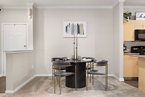 a dining room with a table and chairs a dining room with a table and chairs at Artisan Apartments & Shops, Austin, TX