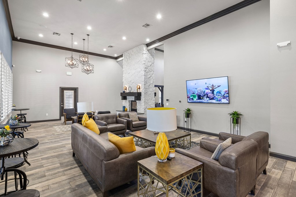 a living room with couches and chairs and a fireplace at Sonterra Apartment Homes, Austin, TX