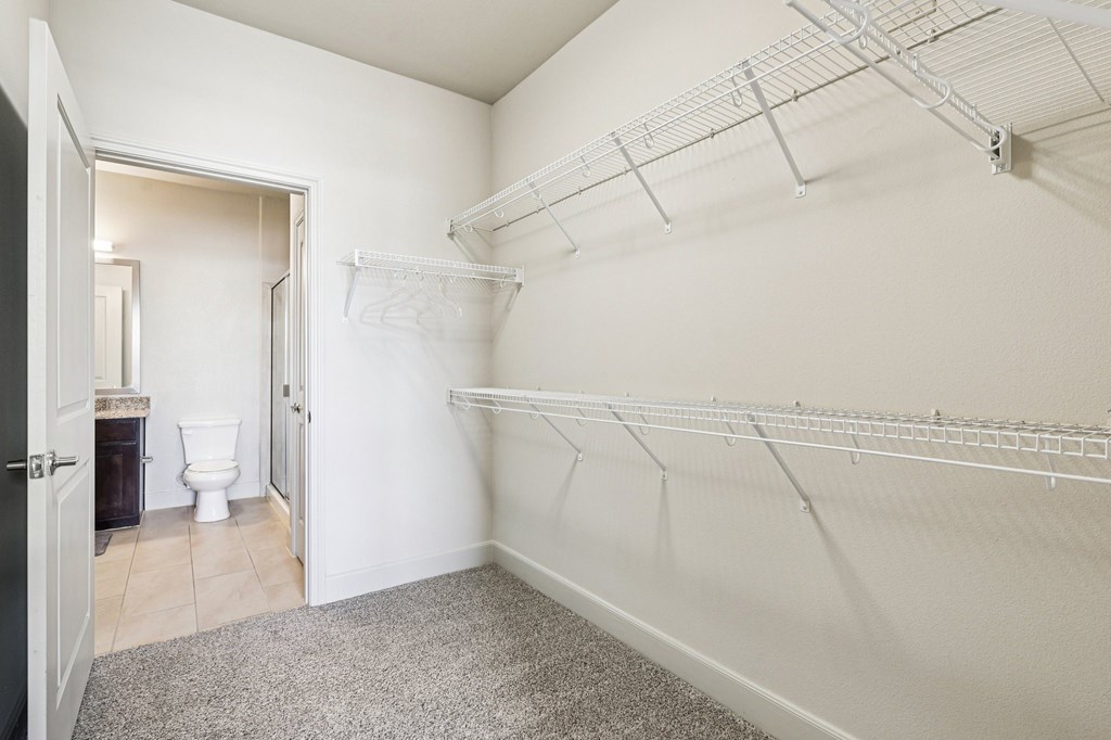 A white wall with a metal rack on it.