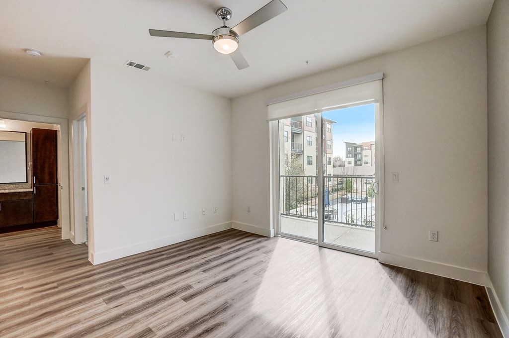a living room with a large window and a ceiling fan at Aurora Watson Branch, Mansfield, TX
