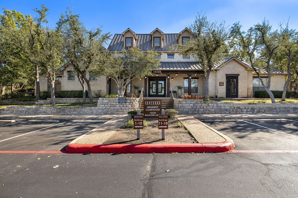a parking lot with a sign in front of a house at Sonterra Apartment Homes, Austin, TX