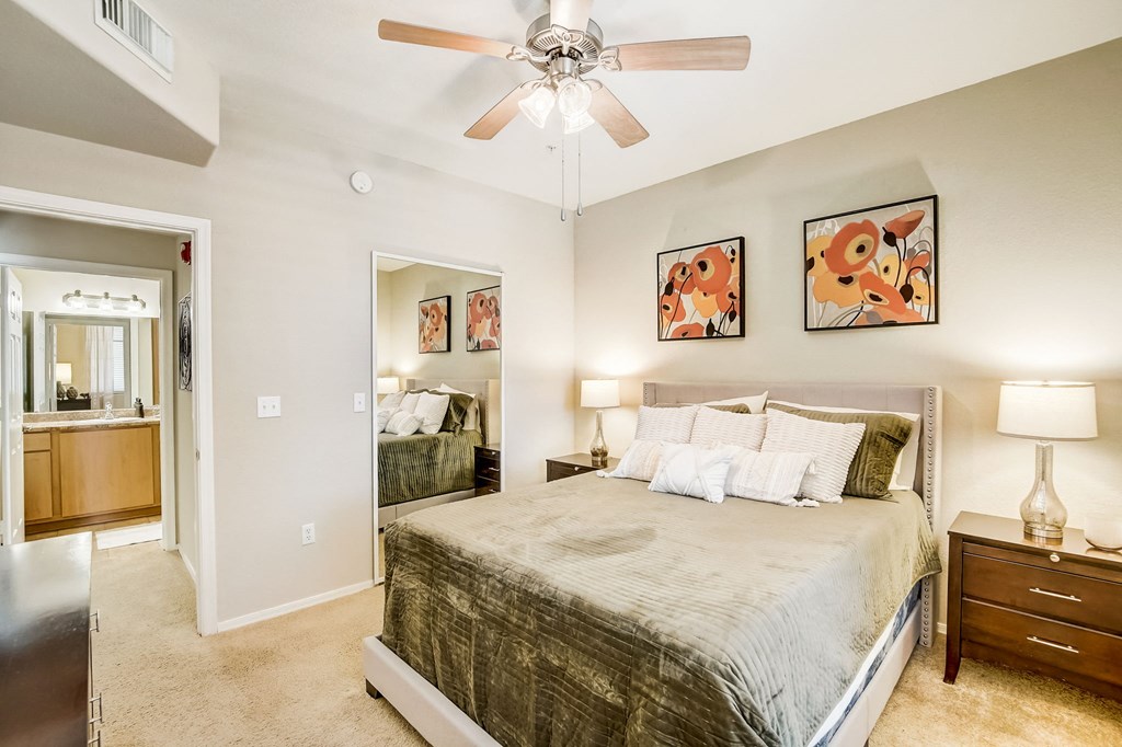 a bedroom with a large bed and a ceiling fan  at Adiamo Palm Valley, Arizona