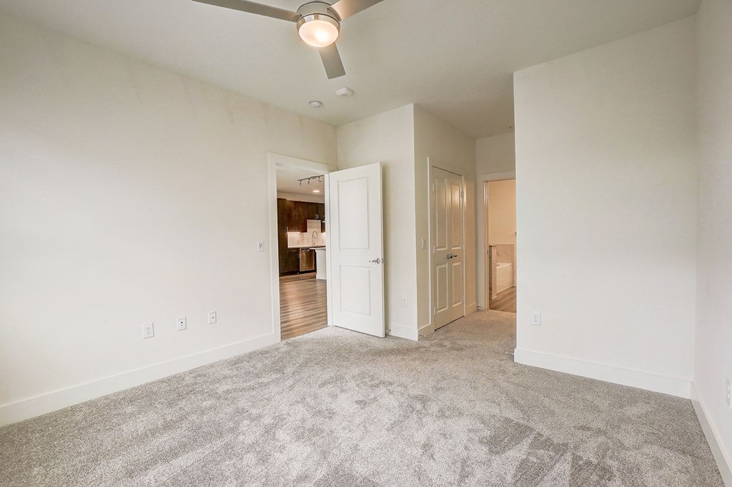an empty living room with carpet and a ceiling fan at Aurora Watson Branch, Texas, 76063