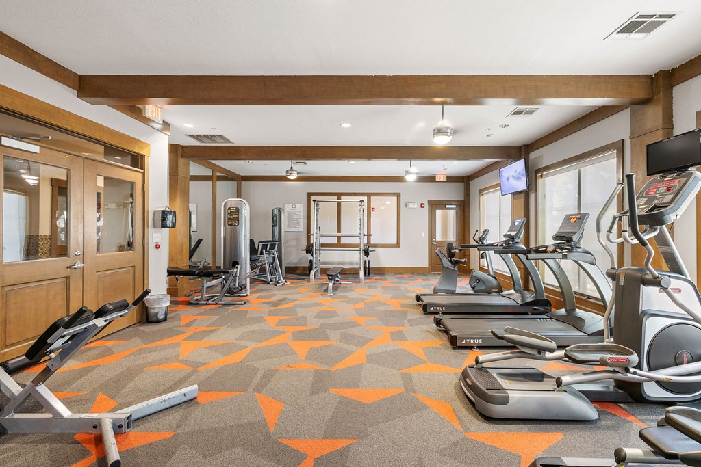 a gym with treadmills and other exercise equipment in a room at Lakeline East Apartments, Cedar Park, TX