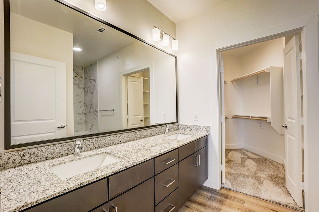 a bathroom with granite counter tops and a large mirror at Aurora Watson Branch, Texas, 76063