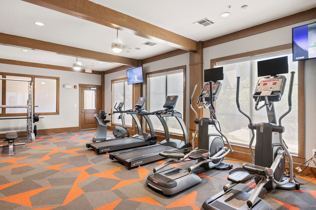 a gym with treadmills and other exercise equipment in a room at Lakeline East Apartments, Cedar Park, 78613