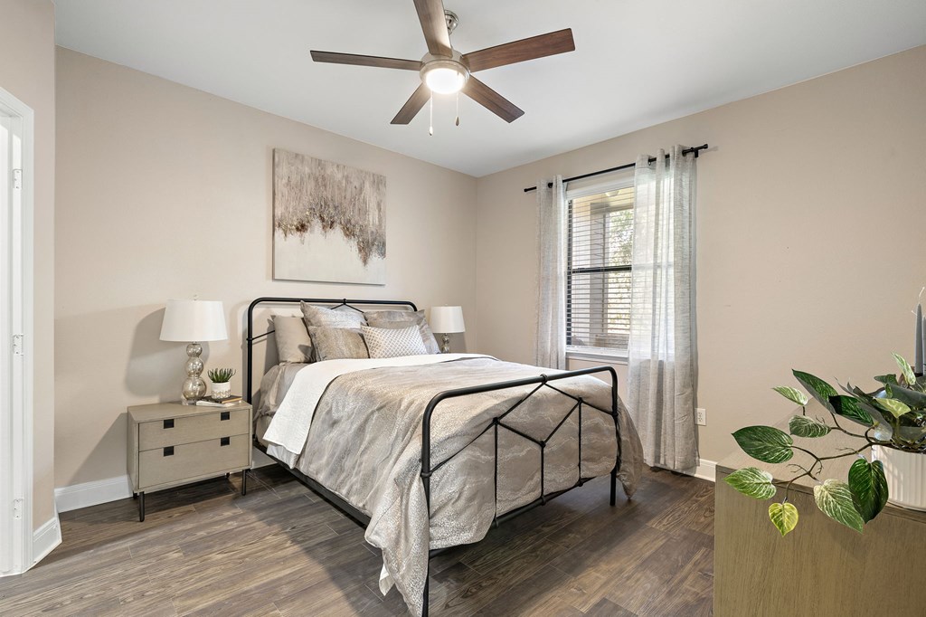 a bedroom with a ceiling fan and a bed at The Verandah, Texas