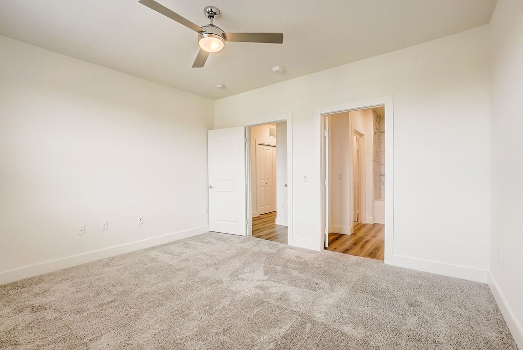a spacious living room with carpet and a ceiling fan at Aurora Watson Branch, Mansfield, 76063