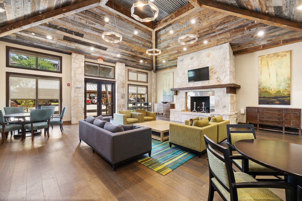 a living room with couches and chairs and a fireplace at Lakeline East Apartments, Texas, 78613