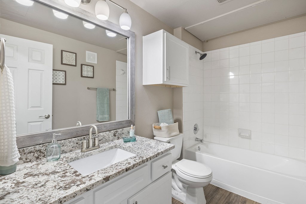 a bathroom with a sink and a toilet and a tub at Sonterra Apartment Homes, Austin, Texas